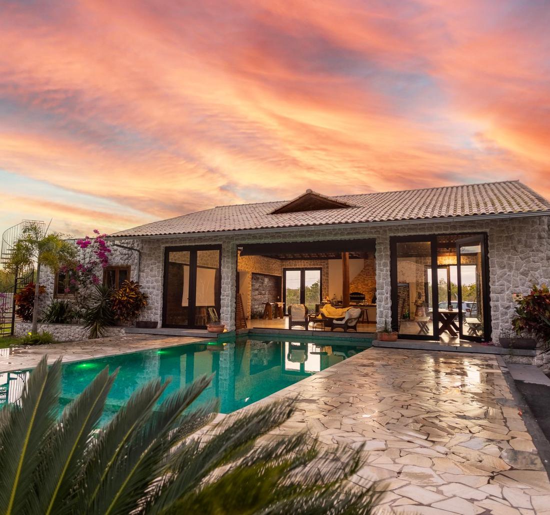 A house and pool at sunset